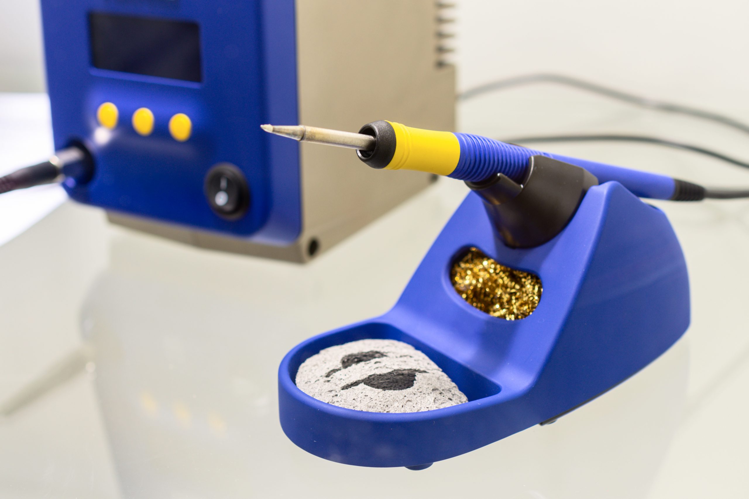Soldering iron with a tip cleaner