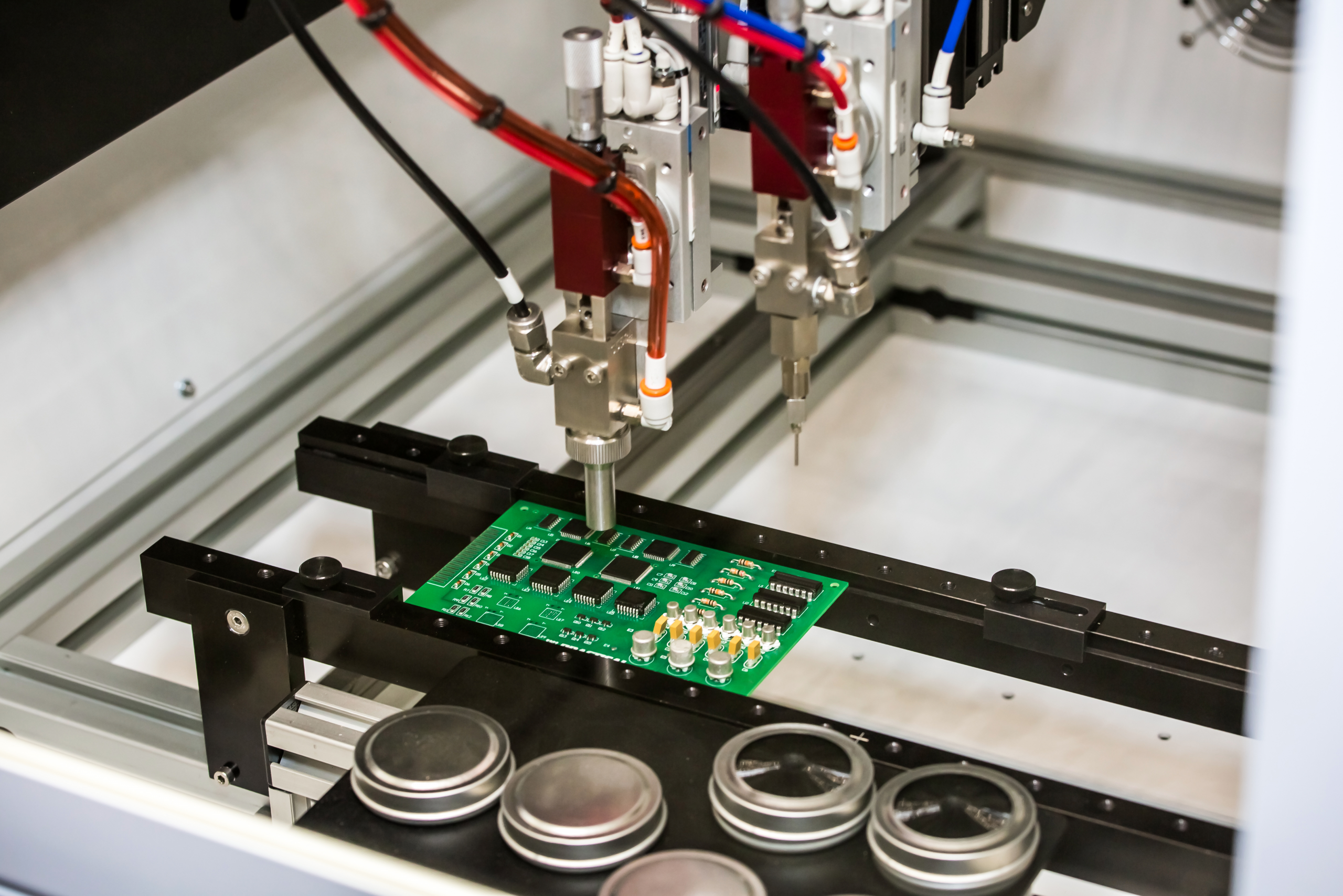 Application of conformal coating by a flexible robotic machine